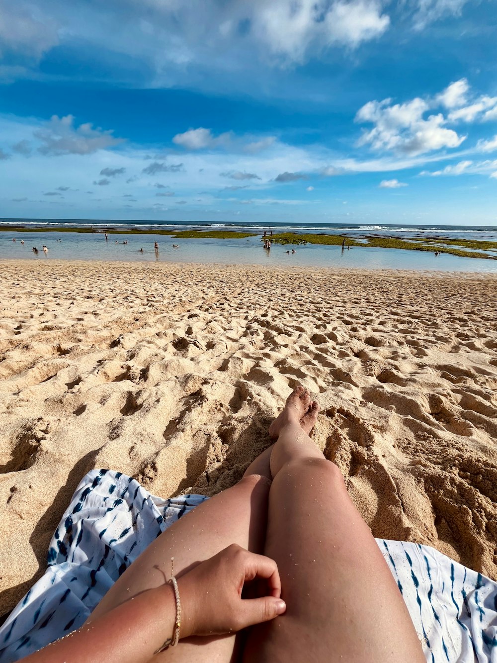 a person laying on a towel on a beach