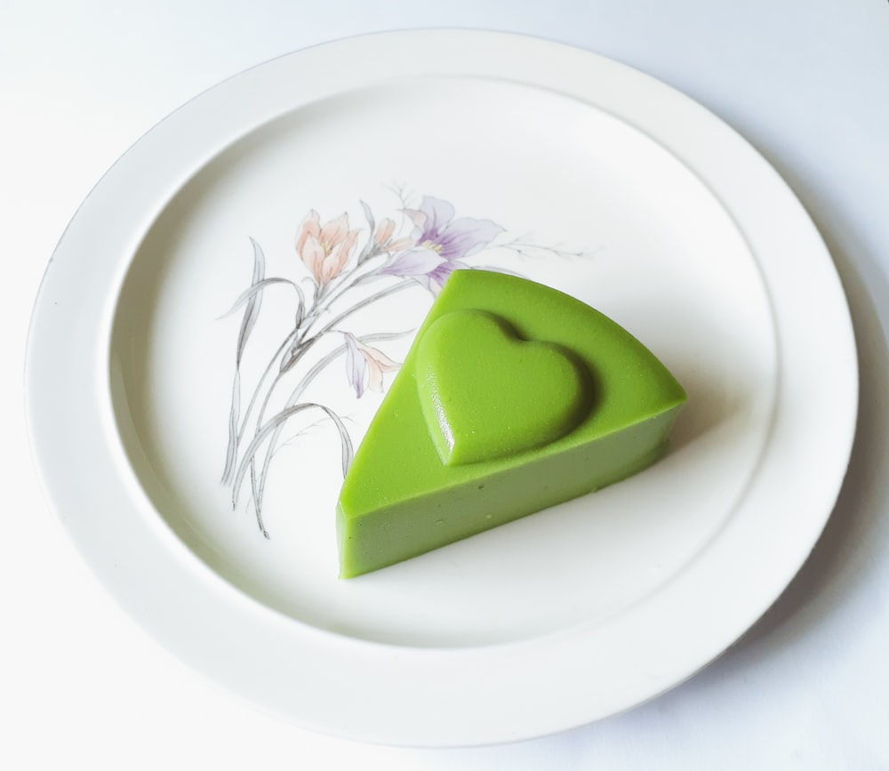 a piece of green cake on a white plate