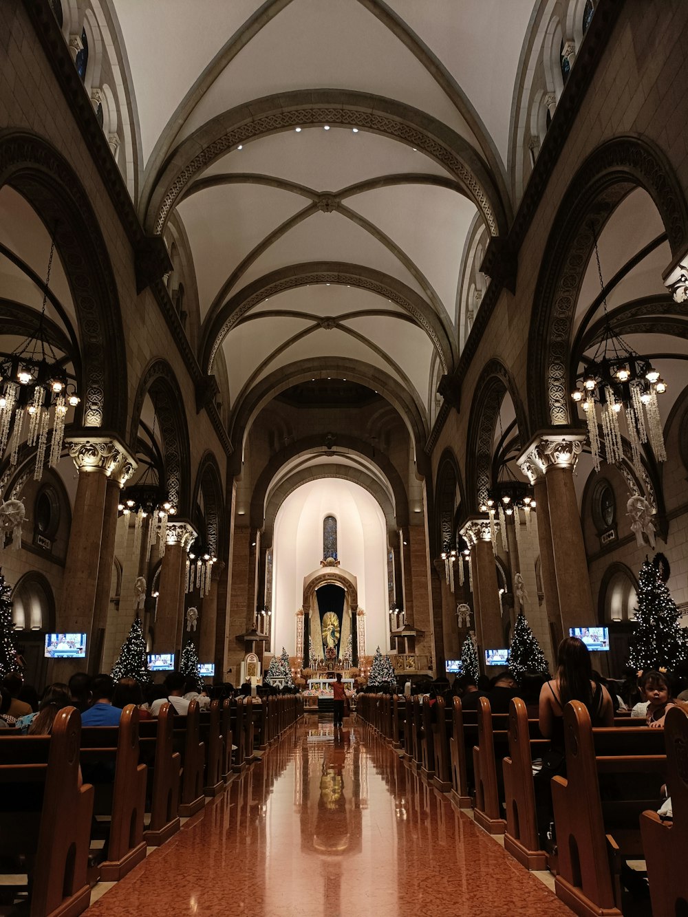 a church filled with lots of pews covered in christmas decorations