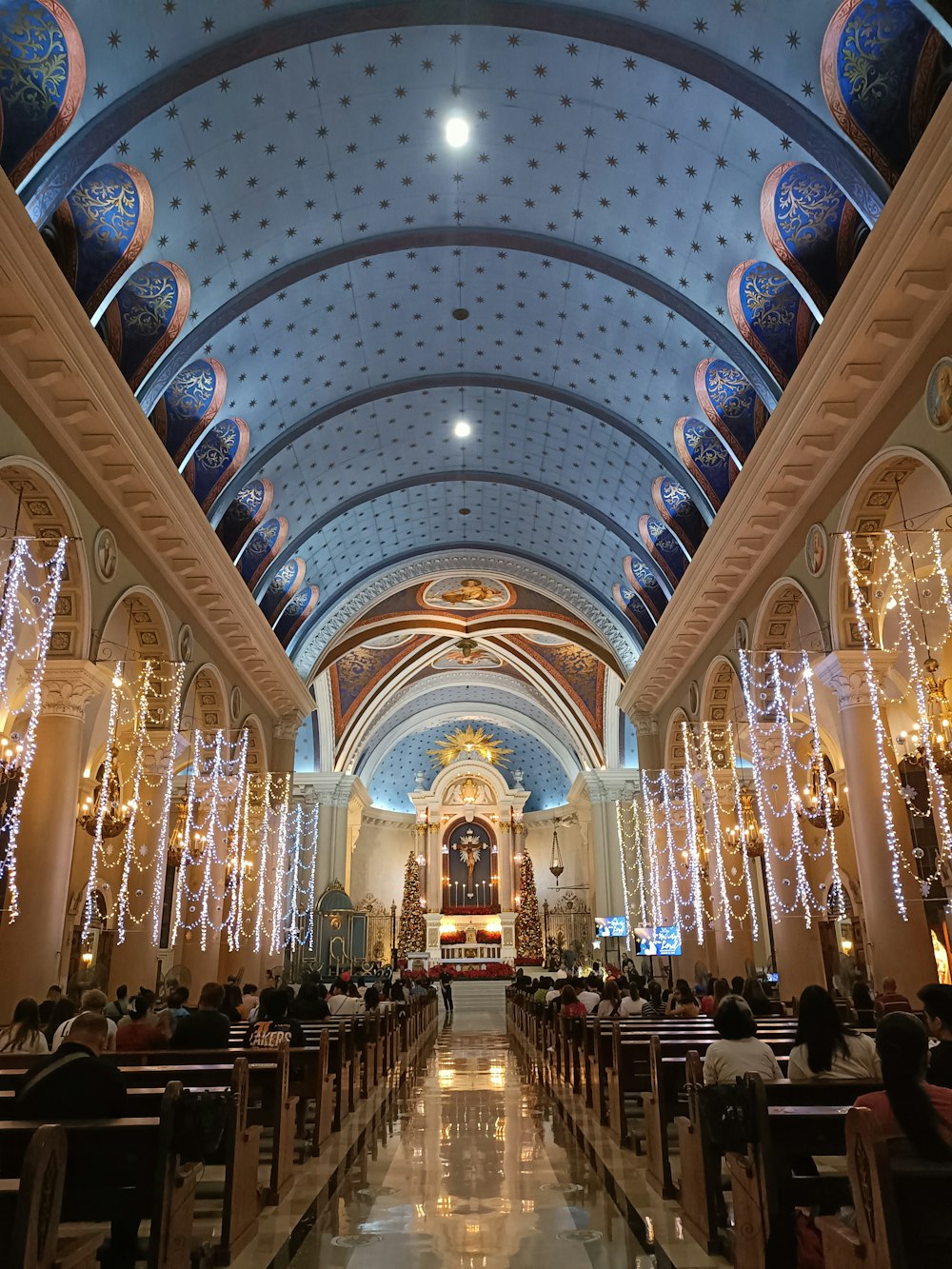 a church with a ceiling decorated with lights