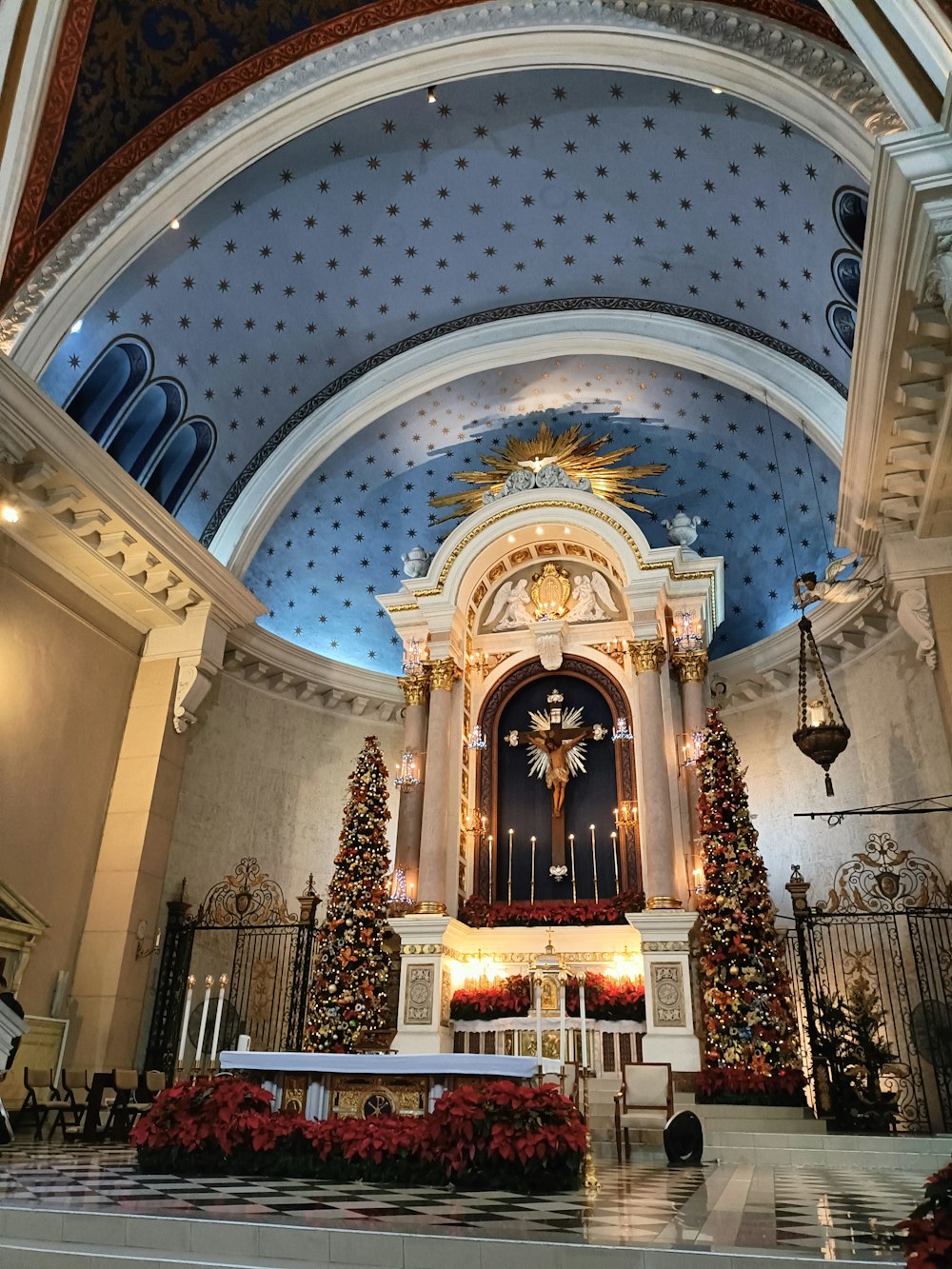 a church decorated for christmas with a blue ceiling