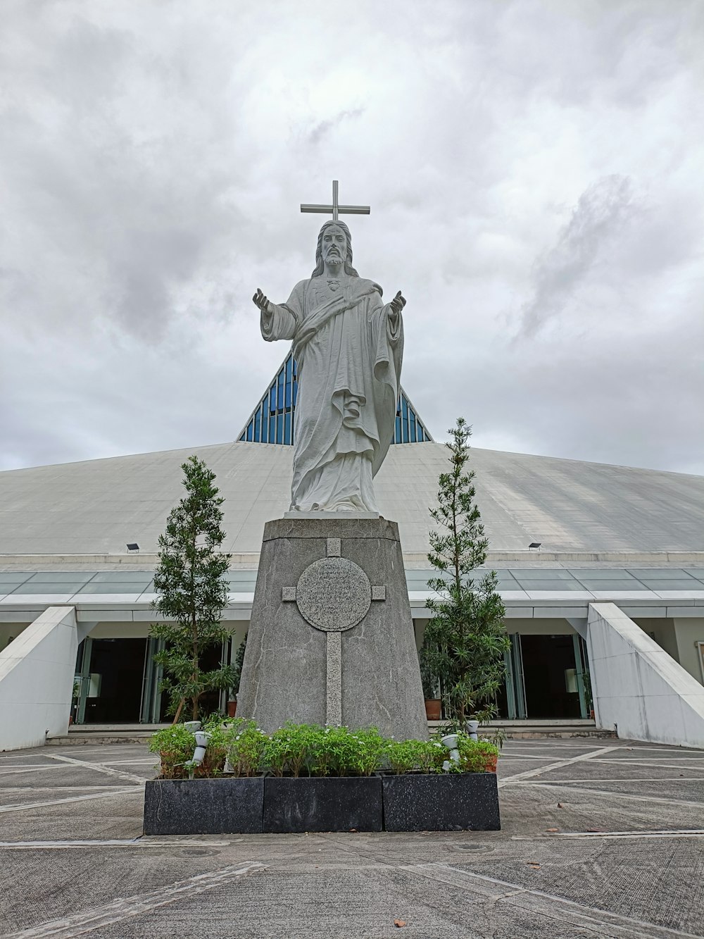 a large statue of jesus in front of a building