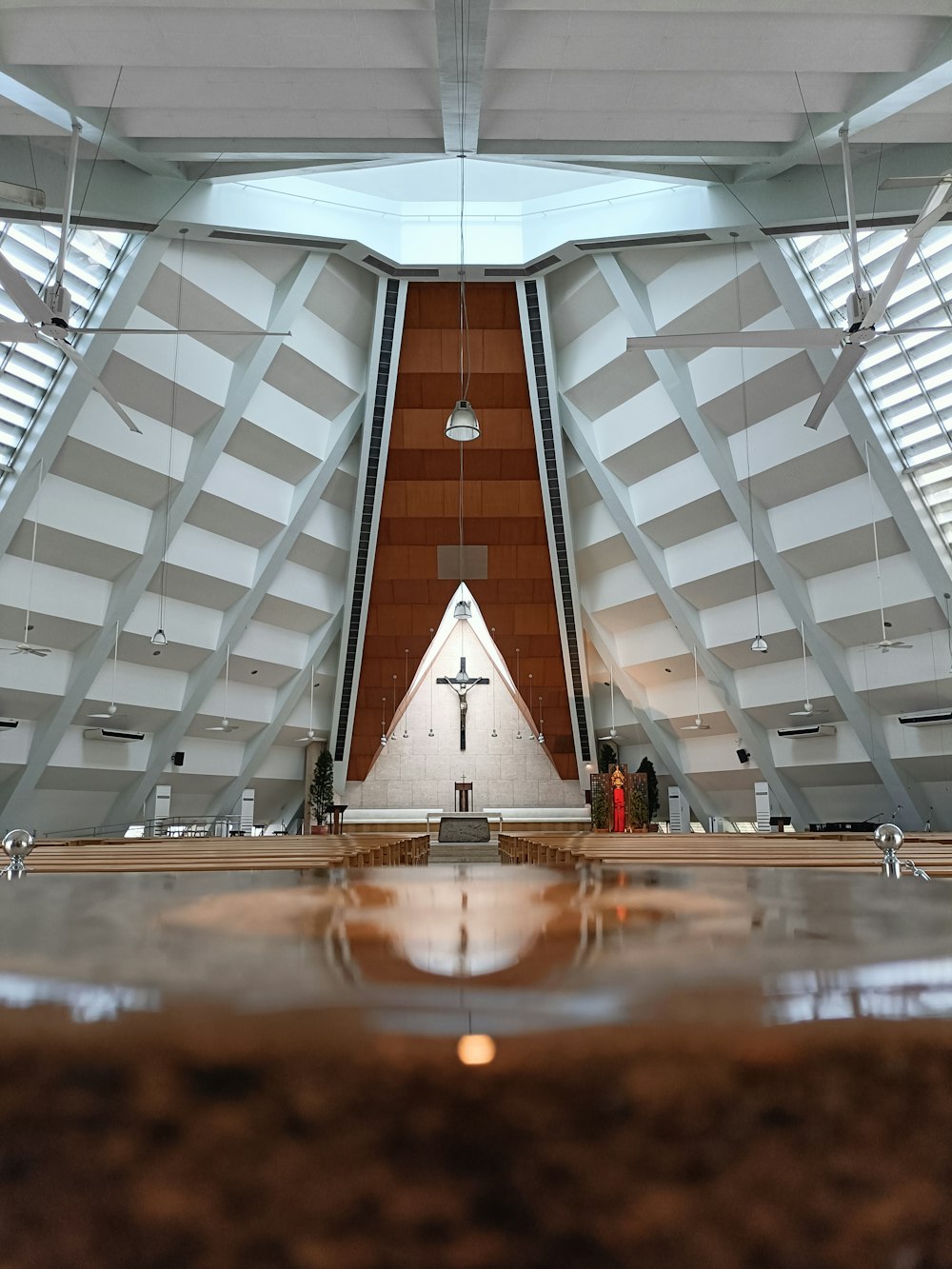 the inside of a church with a cross on the wall