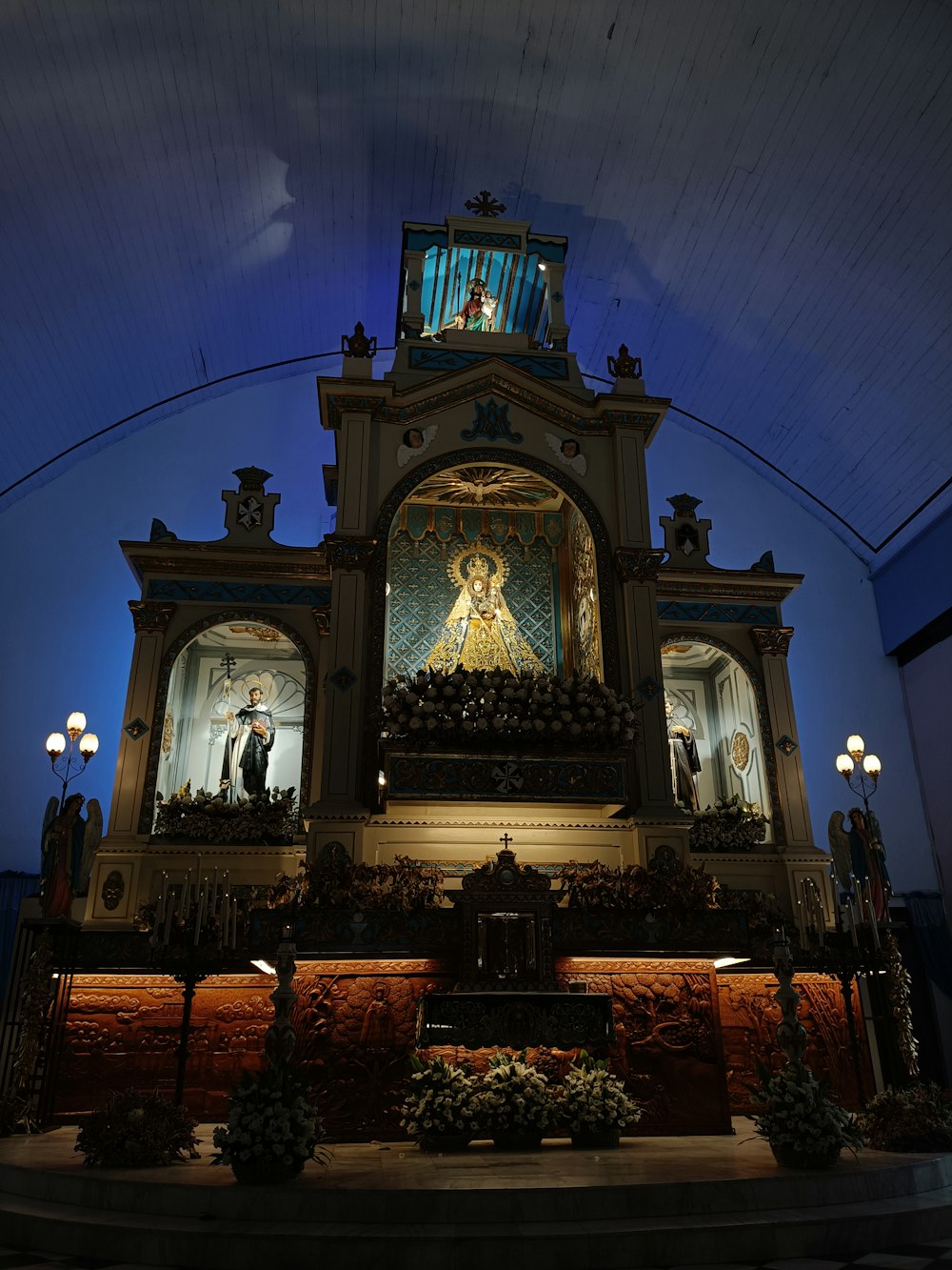 a church with a statue of a person on the alter