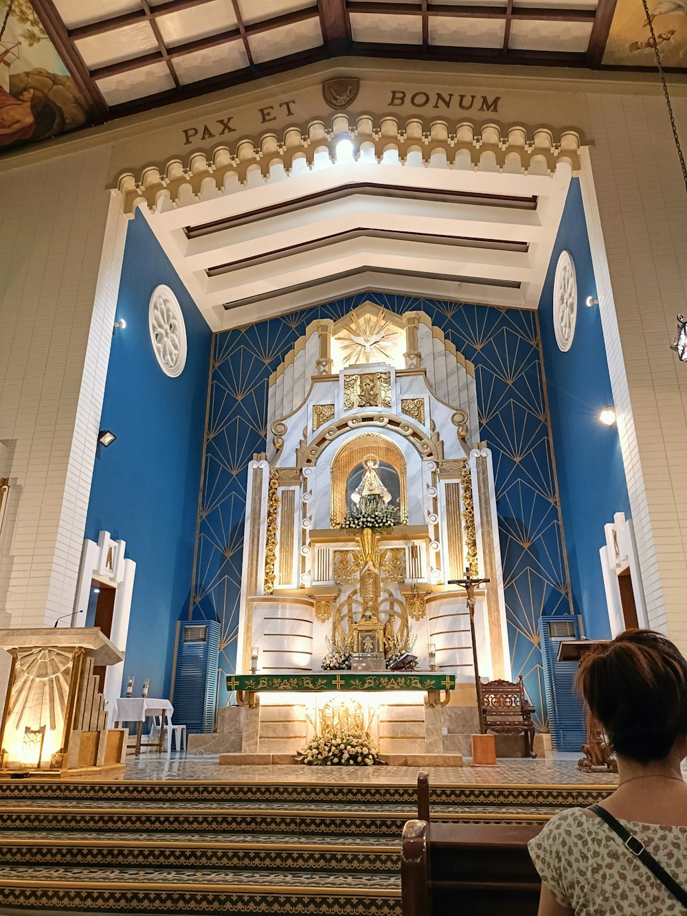 a woman standing in front of a church alter