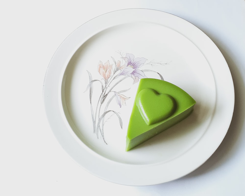 a piece of green cake on a white plate