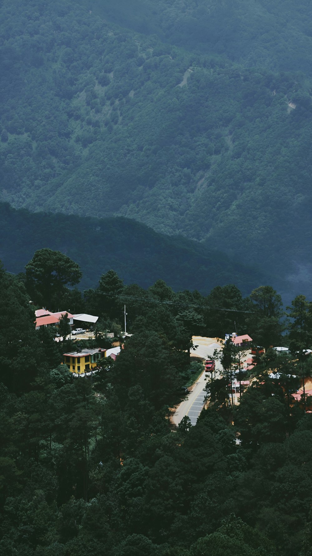 a scenic view of a village in the mountains