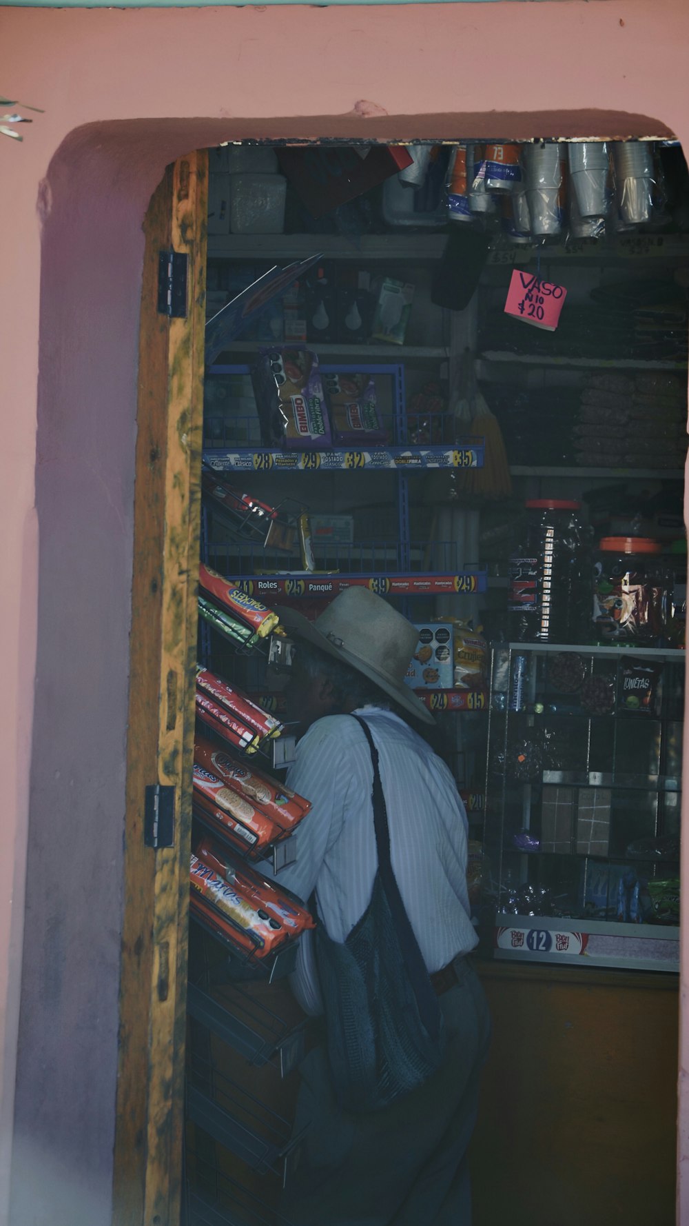 a man with a hat and a bag in a store