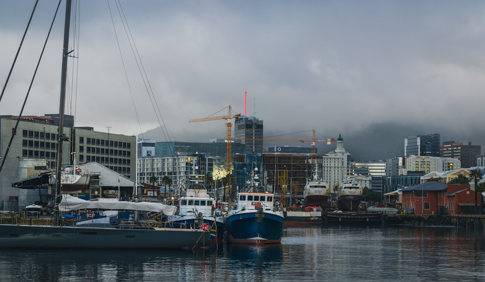 a harbor filled with lots of boats under a cloudy sky