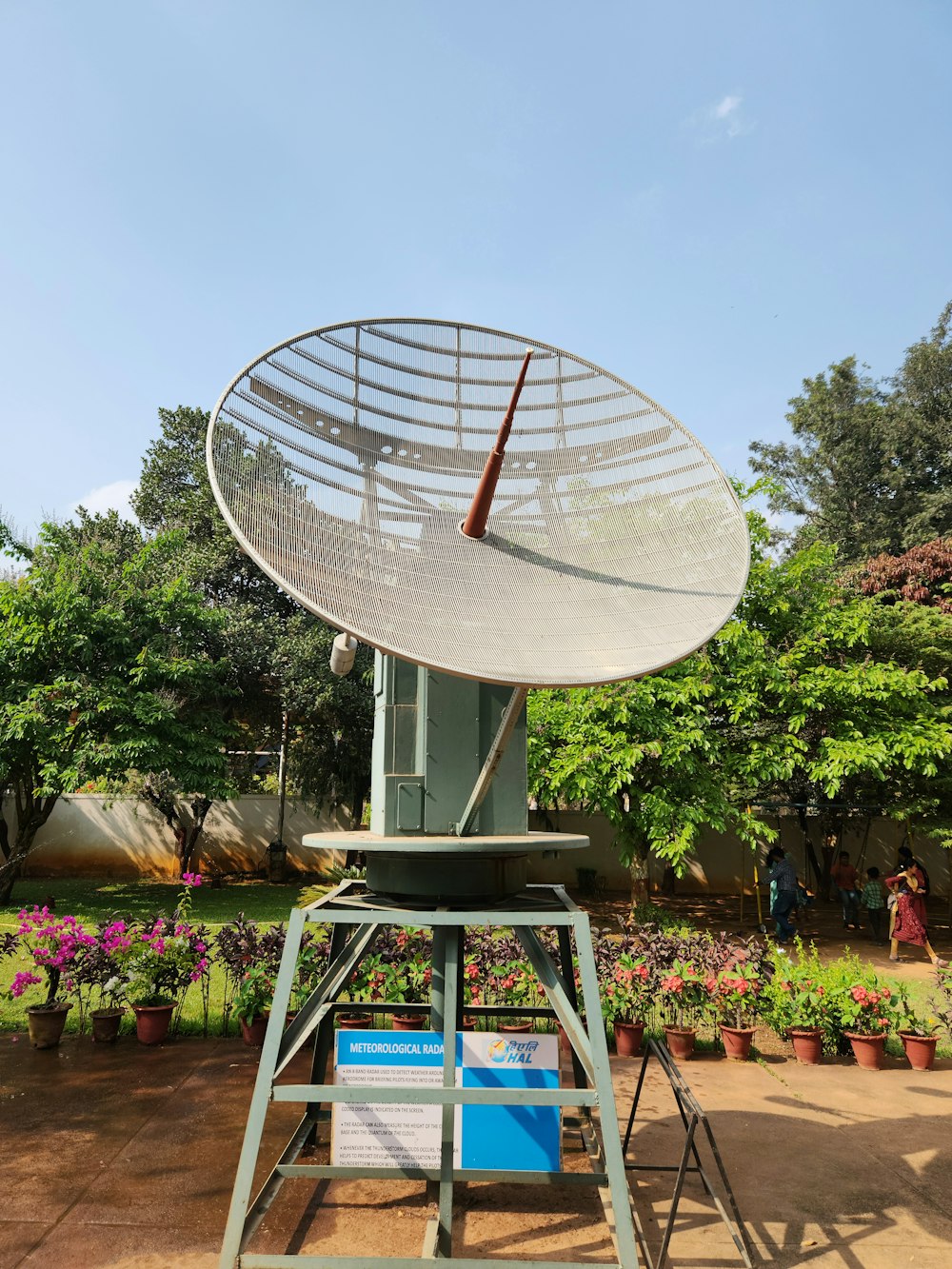 a large satellite dish sitting on top of a metal stand