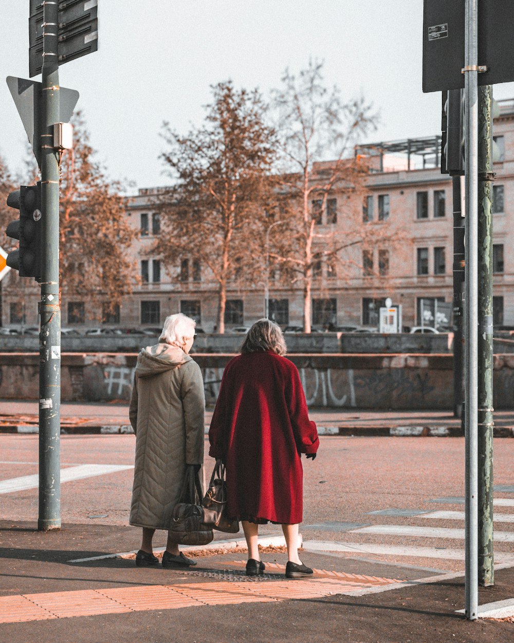 a couple of women standing next to each other on a street