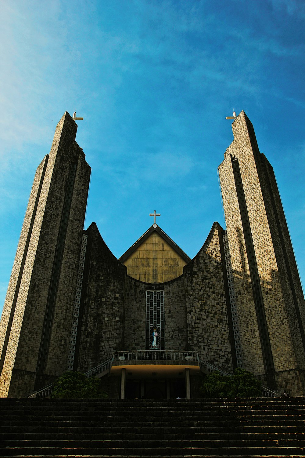 a church with a steeple and stairs leading up to it