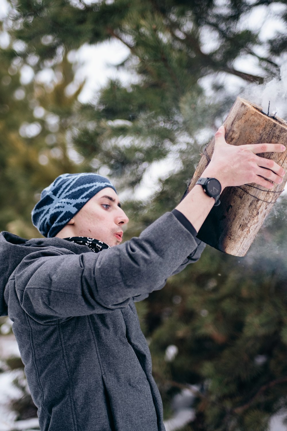 a woman holding a wooden box in the snow