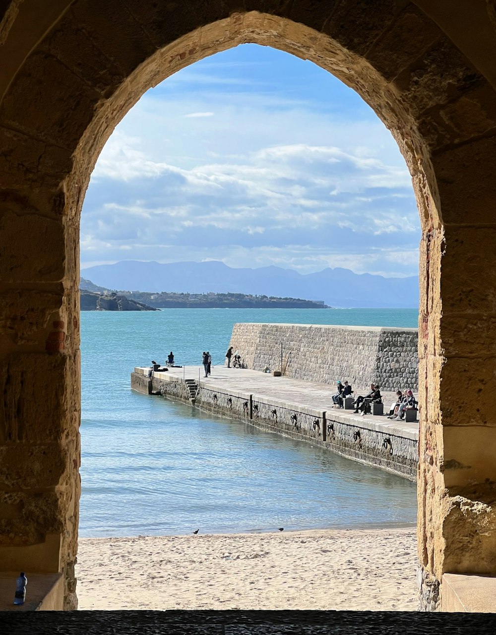 a view of a body of water through an archway