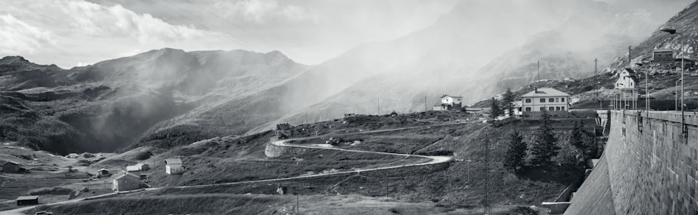 a black and white photo of a mountain road