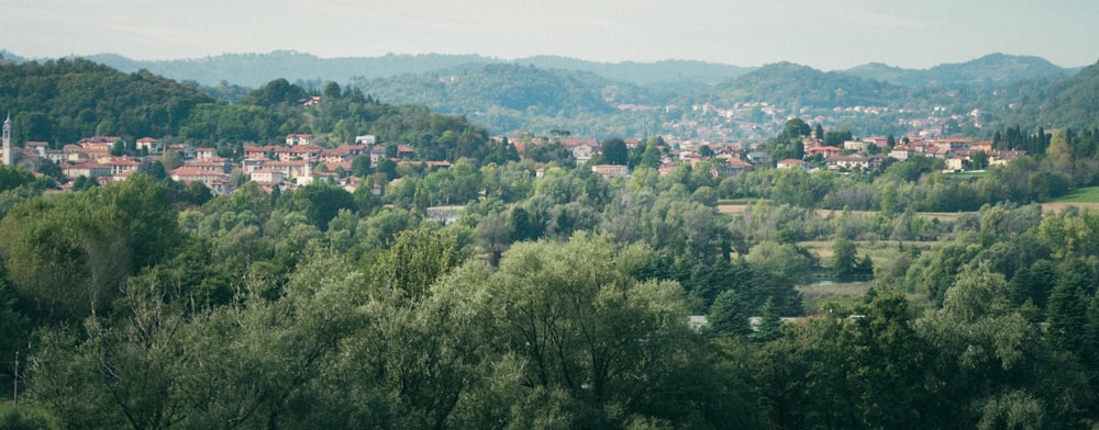 a view of a town in the distance with mountains in the background