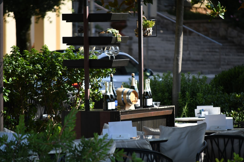 a dog sitting at a table with bottles of wine