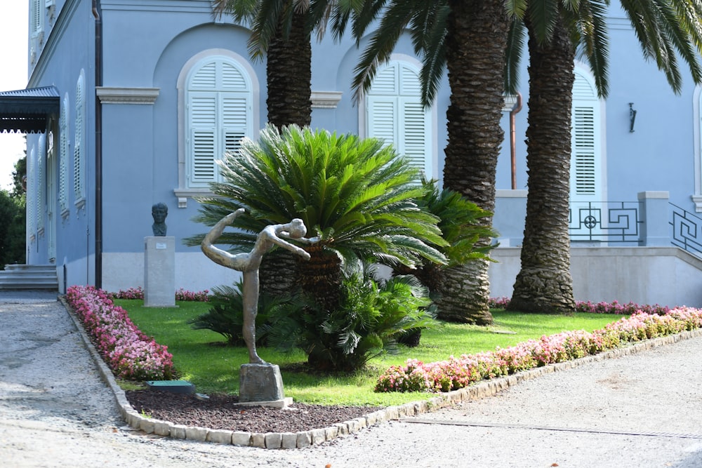 a blue house with palm trees in front of it