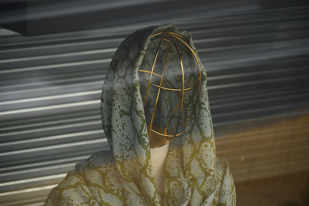 a mannequin's head is covered with a cloth