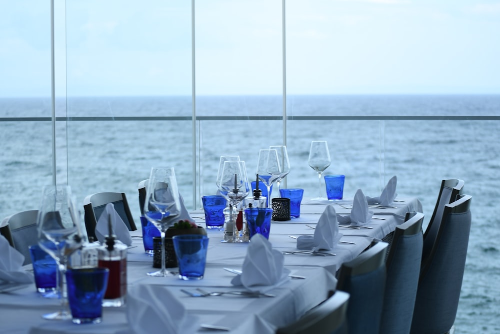 a table set up with wine glasses and napkins