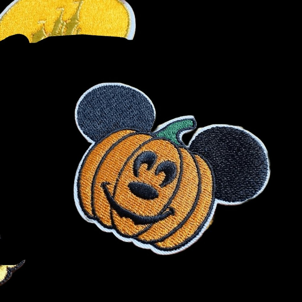 a close up of a mickey mouse pumpkin
