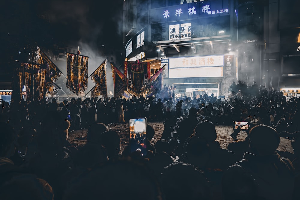 a crowd of people standing in front of a building