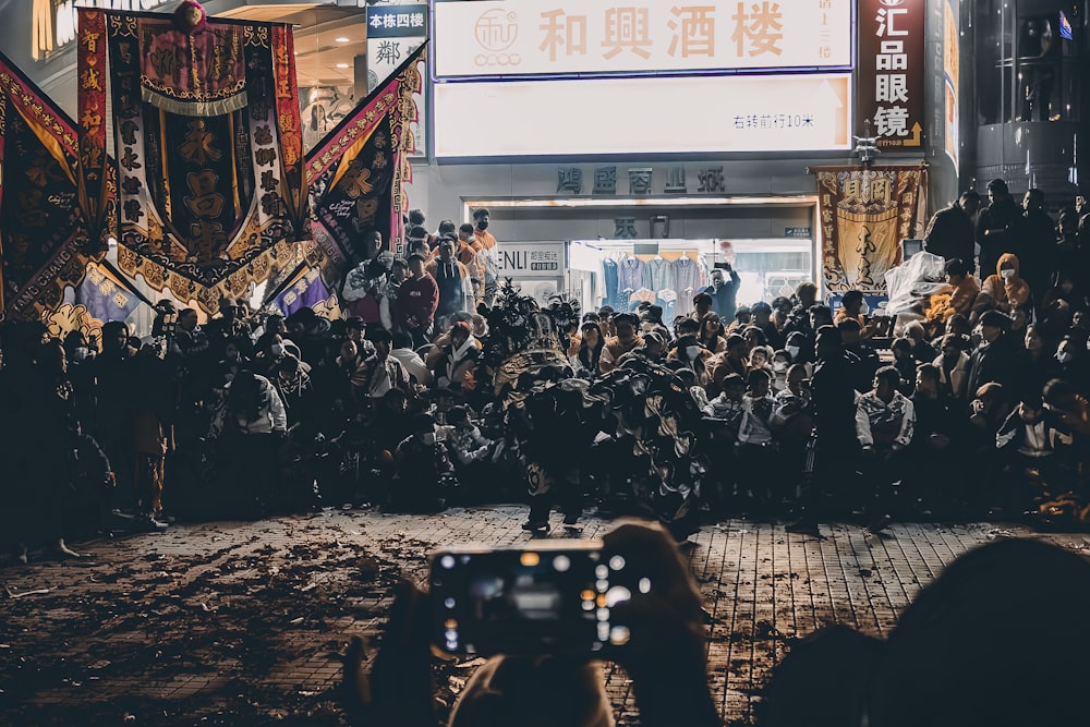 a crowd of people standing in front of a building