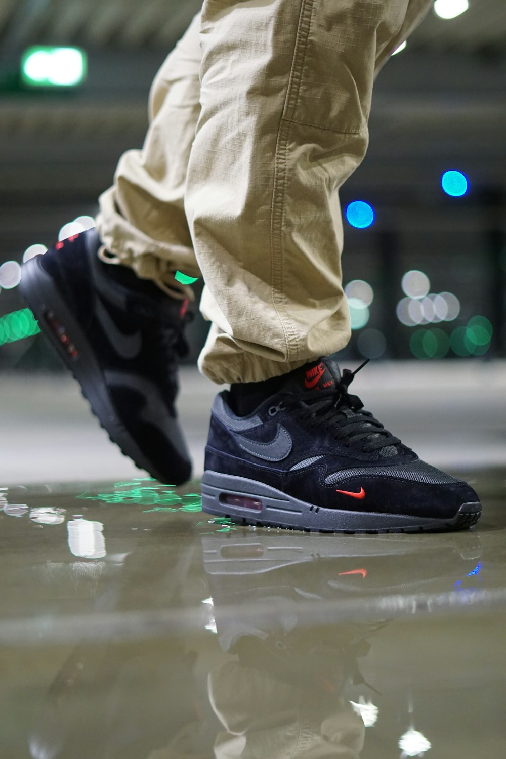 a close up of a person's shoes on a shiny surface