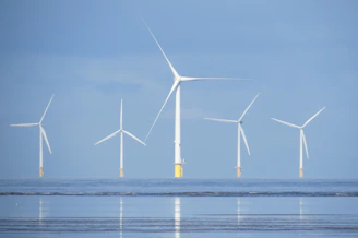 a group of wind turbines in the ocean