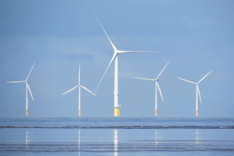 a group of wind turbines in the ocean