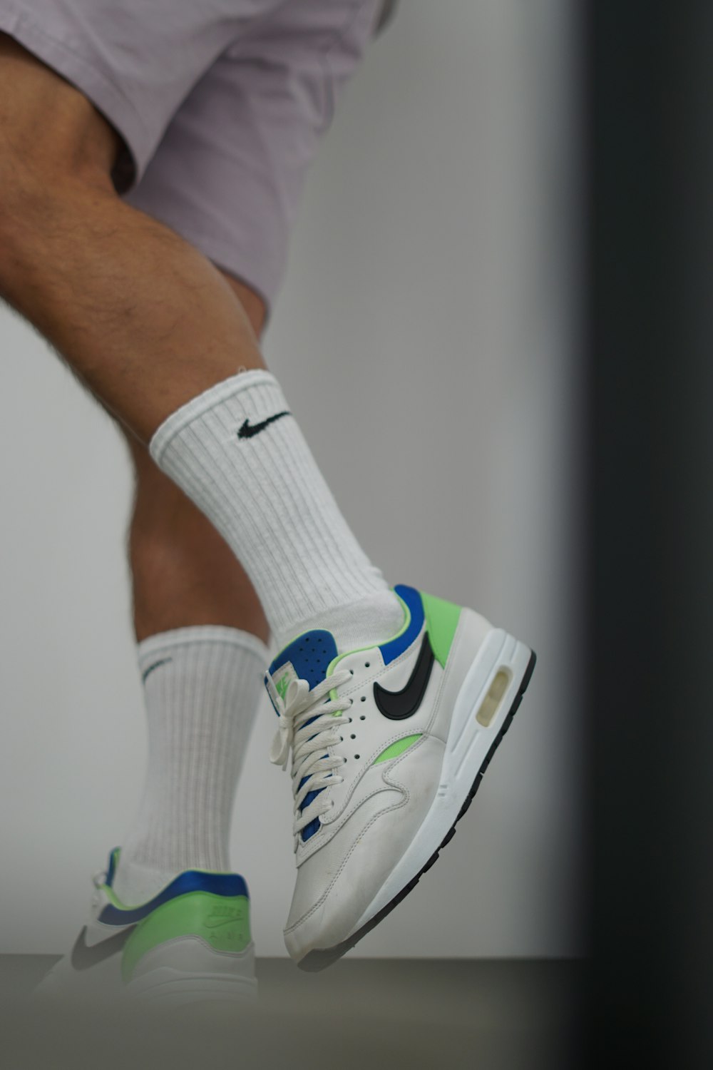 a close up of a person's feet with a pair of tennis shoes
