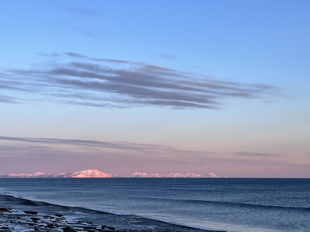 a view of a beach with mountains in the distance