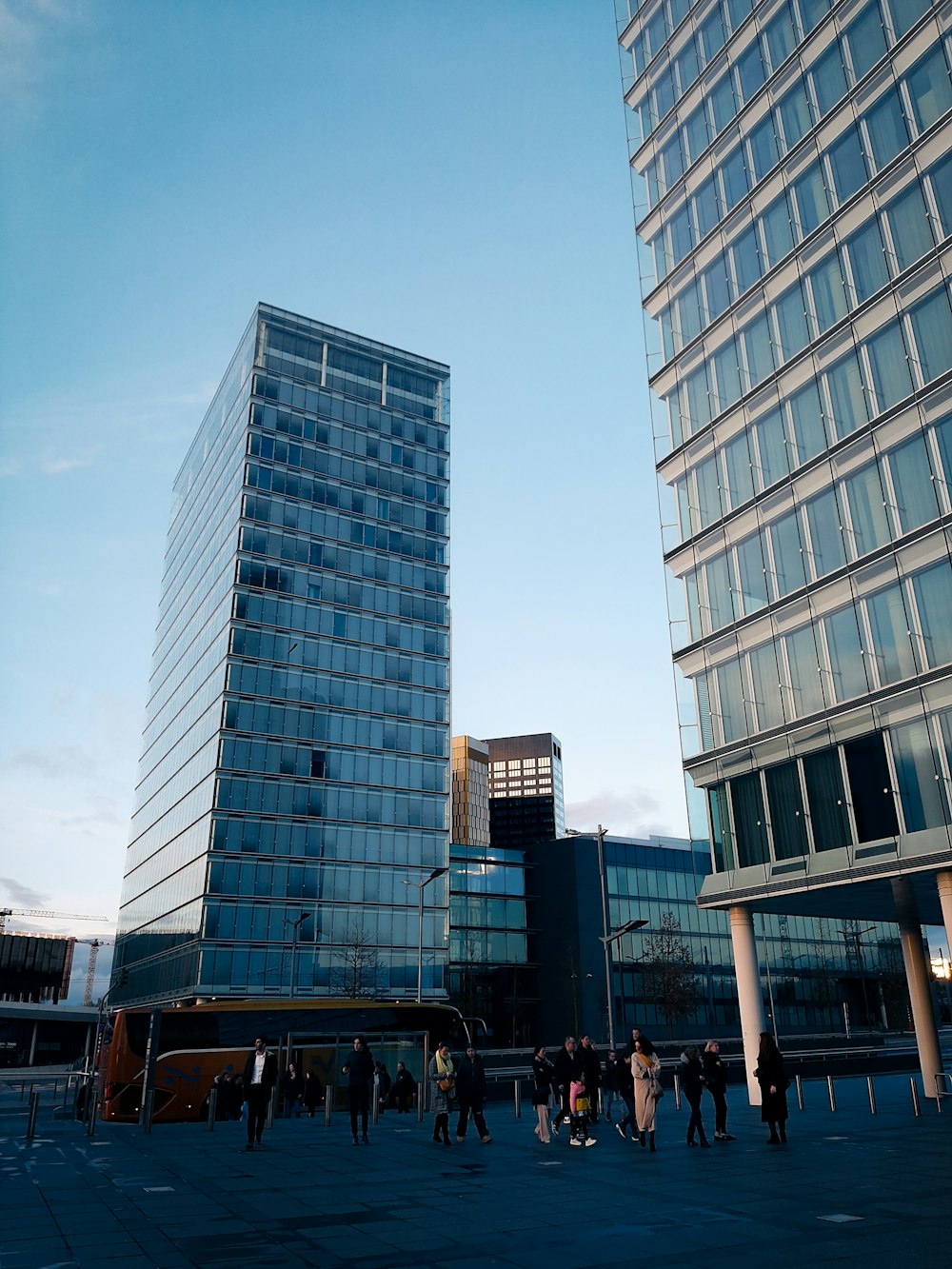 a group of people standing in front of a tall building