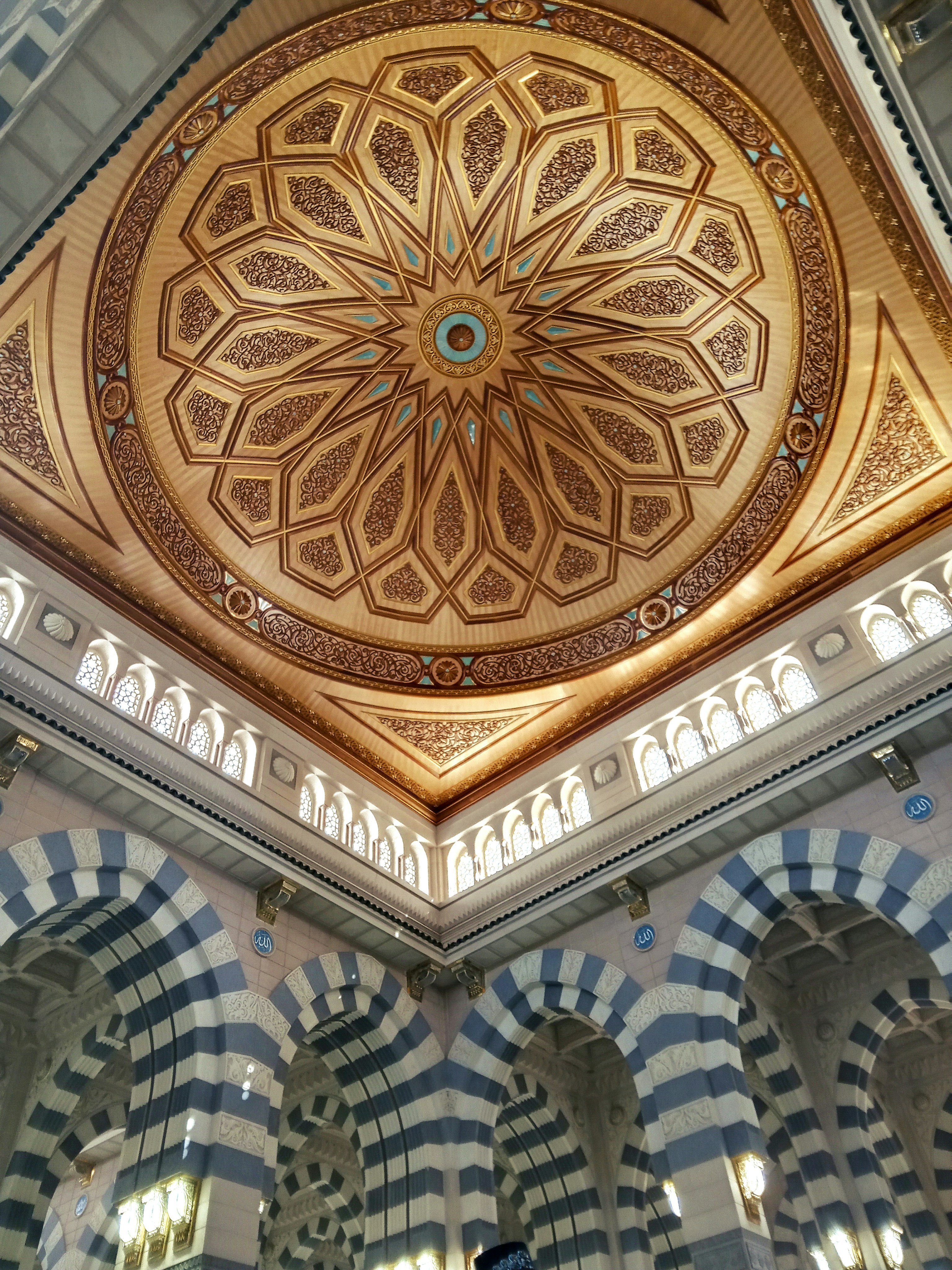 the ceiling of a building with a circular design on it
