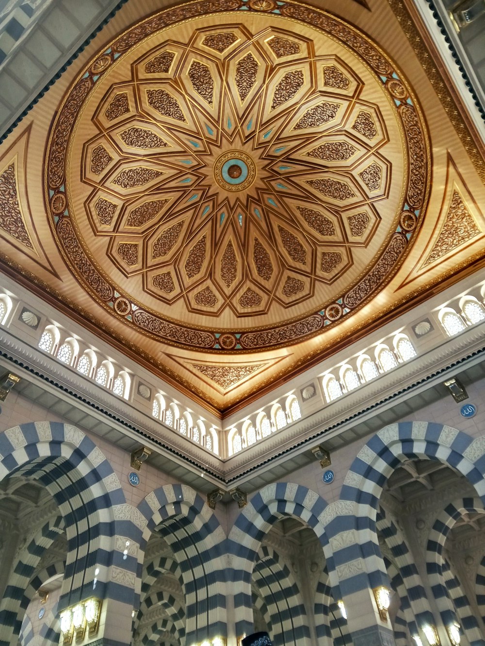 the ceiling of a building with a circular design on it