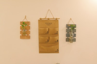 a wall with three pieces of cardboard hanging on it