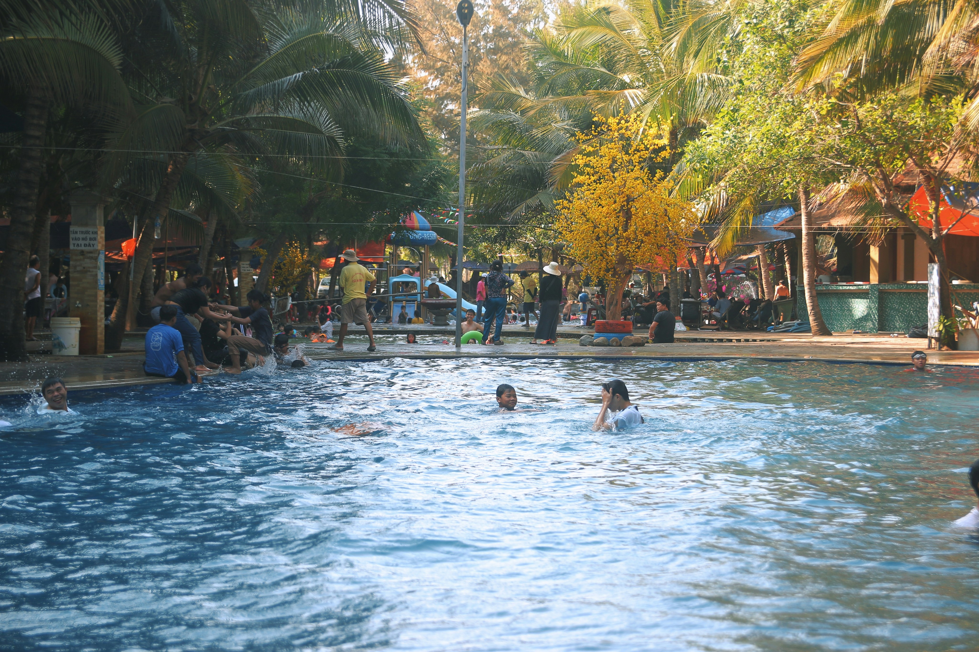 A happy community enjoying a shared amenity like a swimming pool or park - condo association