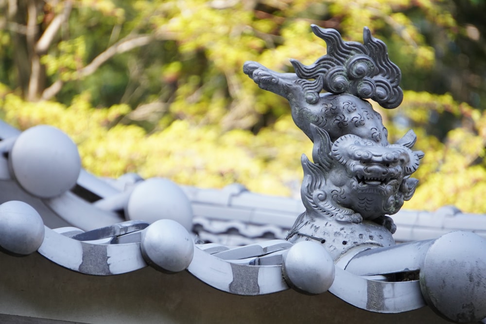 a statue of a dragon on a roof