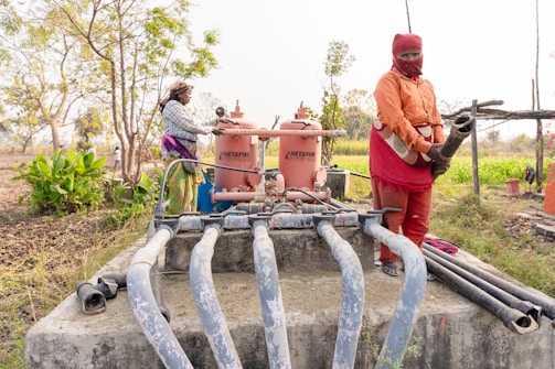 a couple of people that are standing near a fire hydrant