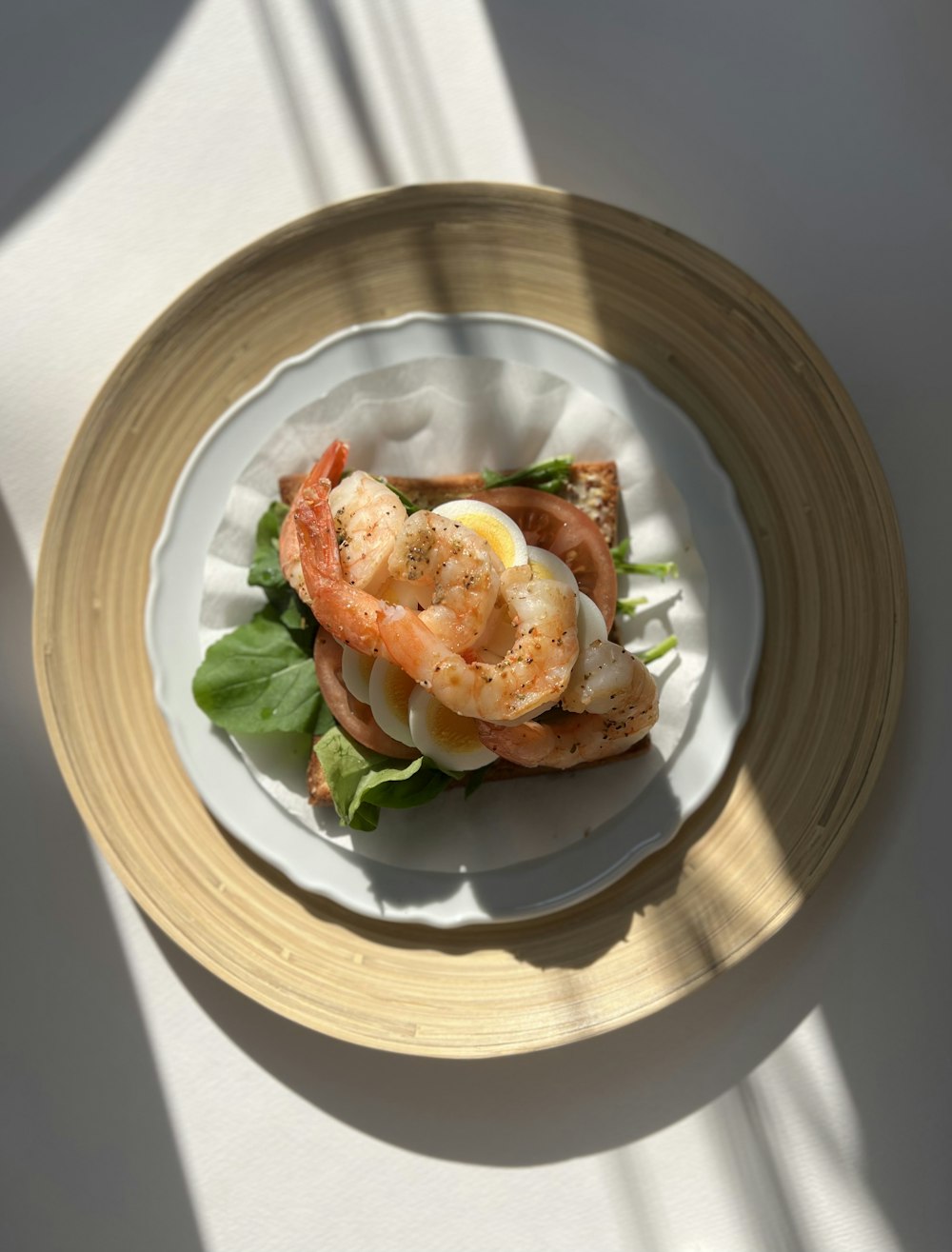 a white plate topped with shrimp and lettuce