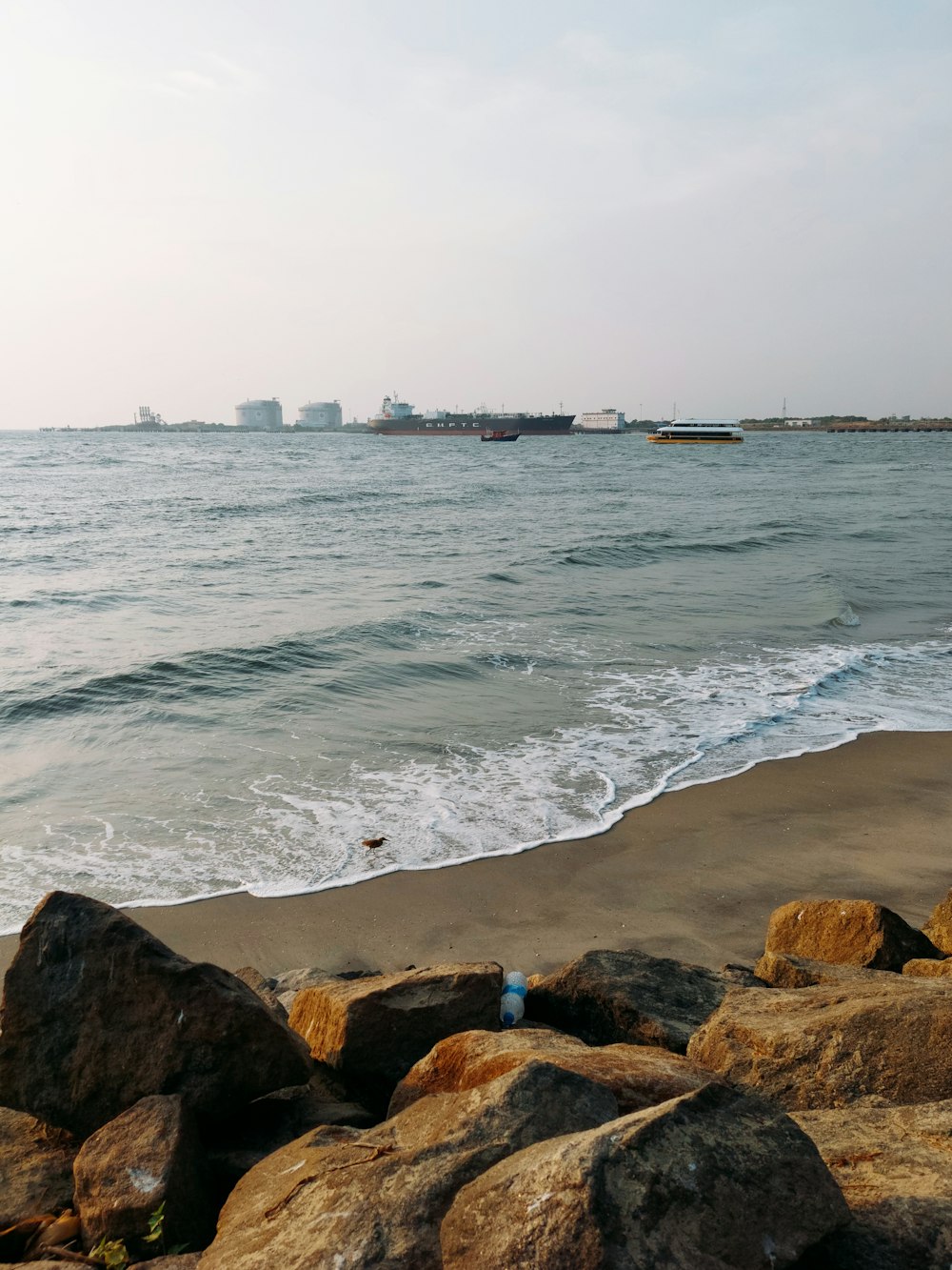 a view of the ocean from a rocky beach