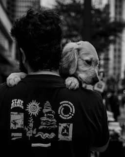 a man carrying a dog on his back