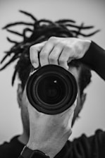 a man holding a camera up to his face