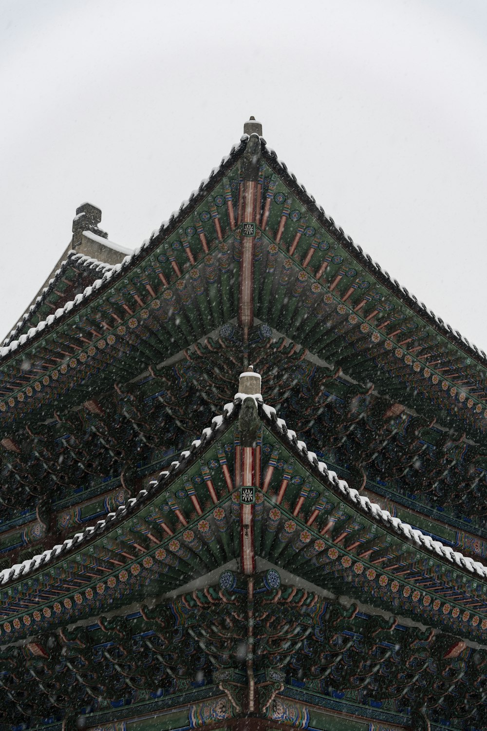 a tall building with a bird sitting on top of it