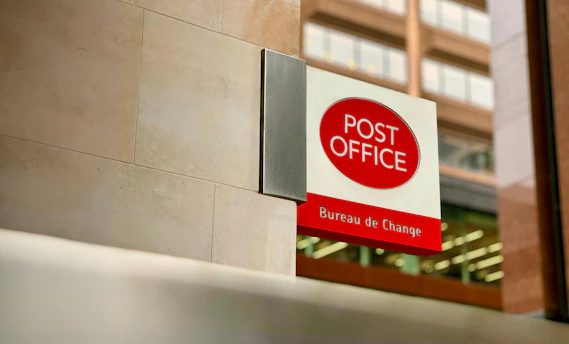a post office sign on the side of a building