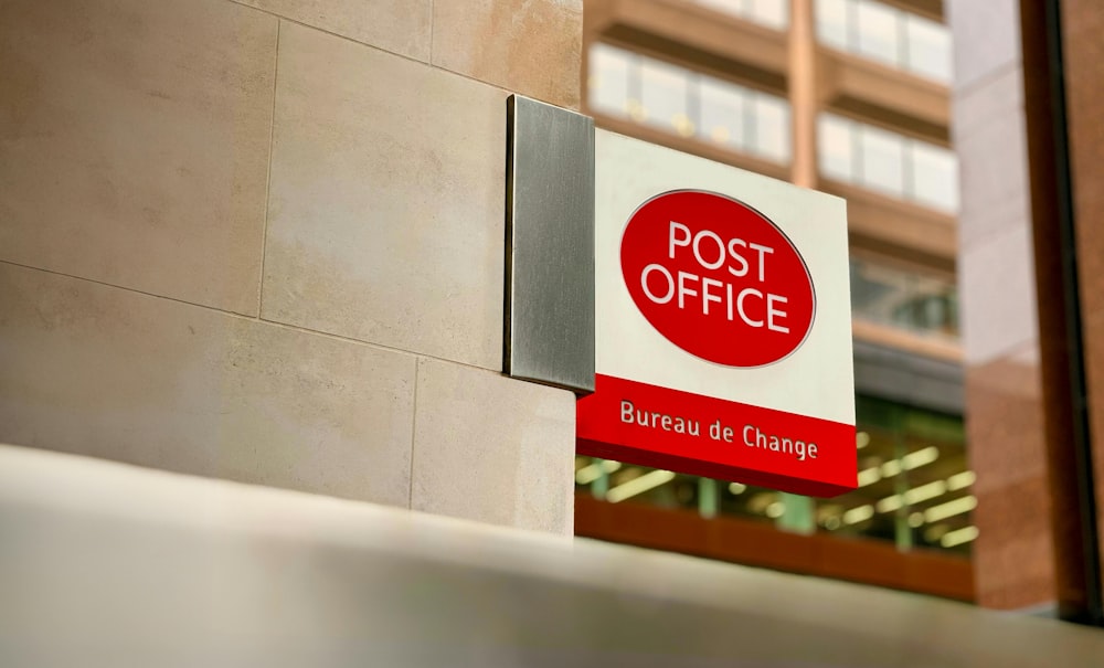 a post office sign on the side of a building