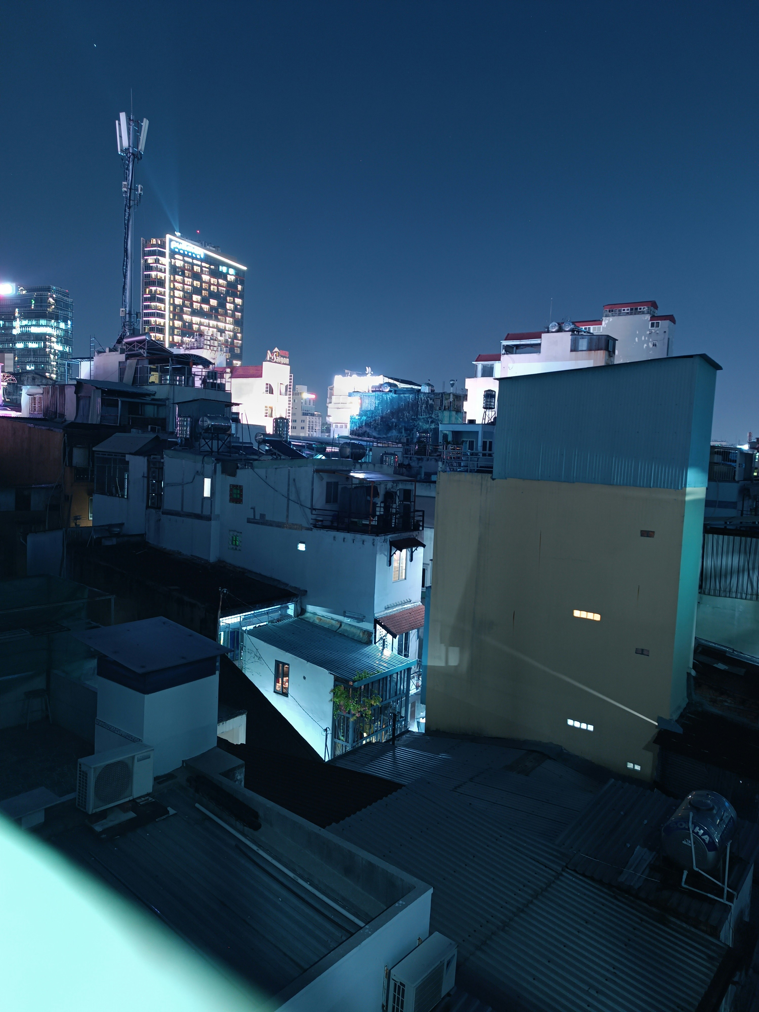 a view of a city at night from a rooftop