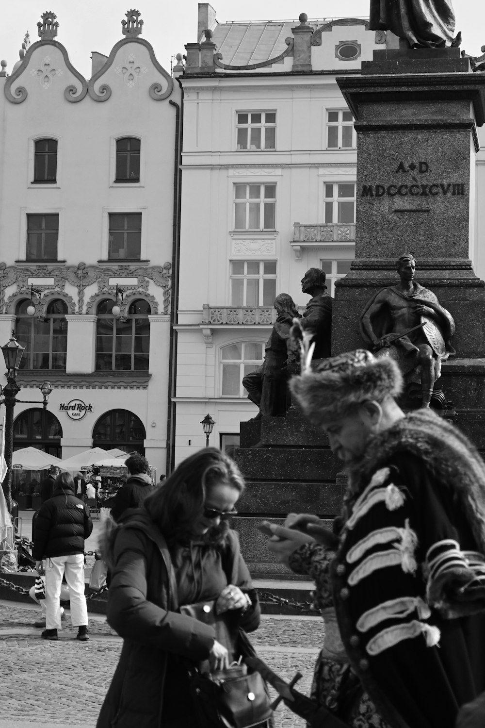 a black and white photo of people walking around