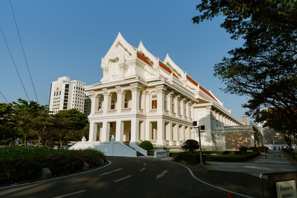 a large white building sitting on the side of a road