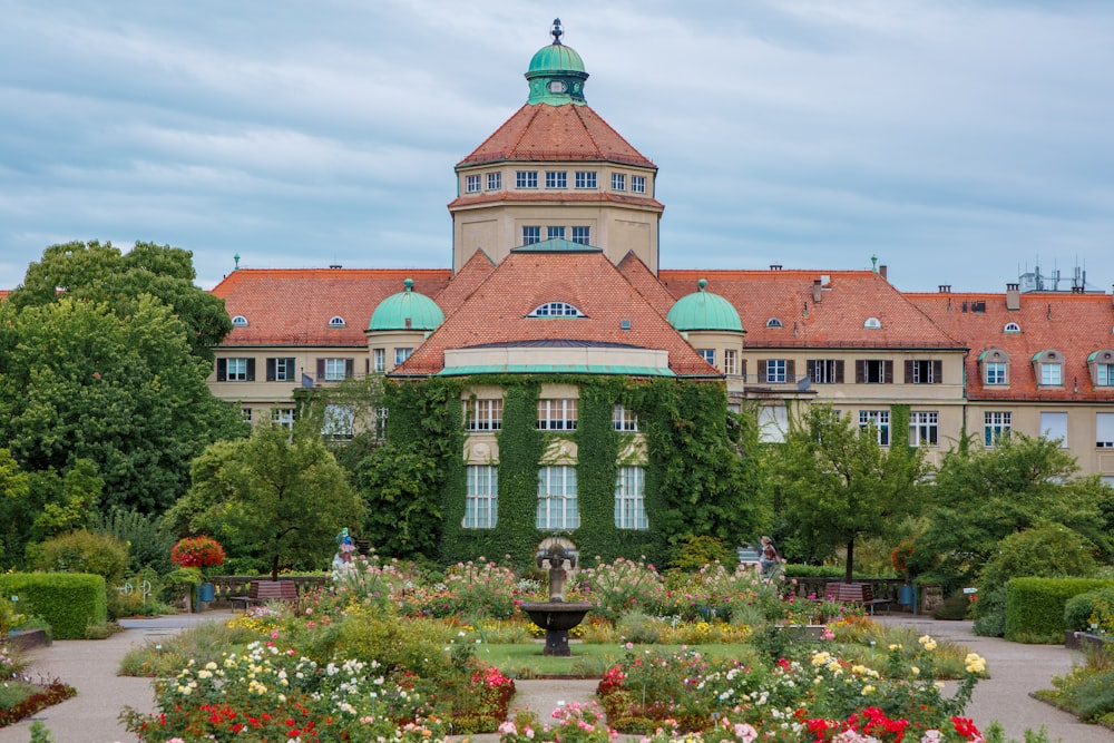 a large building with a garden in front of it